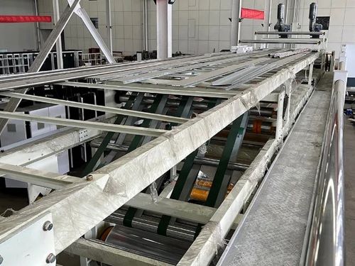 Upper deck of the corrugator bridge conveyor roller system.