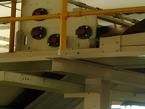 Close-up of the corrugator bridge correction and guide mechanism.