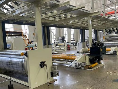 Corrugator bridge frame and conveying equipment on a factory floor.