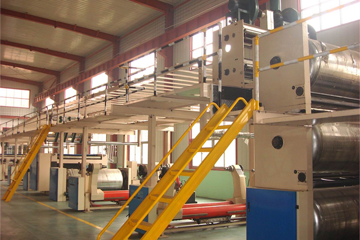 Corrugator bridge installed above a corrugated board production line.